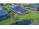 Aerial view showcases a property with a screened-in pool, manicured lawn, and waterfront access at 16307 29Th E Ct, Parrish, FL 34219