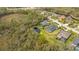 Aerial view of home featuring a screened pool, pond and lush surroundings at 16307 29Th E Ct, Parrish, FL 34219