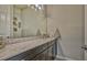 Bathroom features a large mirror over the vanity with stone countertop and under-cabinet storage at 16307 29Th E Ct, Parrish, FL 34219