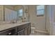 Bright bathroom features a vanity with a marble countertop, white sink, and modern fixtures at 16307 29Th E Ct, Parrish, FL 34219