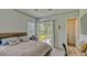 Bedroom with a sliding glass door leading to a screened patio, complemented by a calming color palette at 16307 29Th E Ct, Parrish, FL 34219