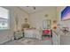 A well-lit bedroom boasts a vanity, desk, and large window with neutral decor at 16307 29Th E Ct, Parrish, FL 34219