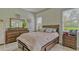 Bedroom with a well-appointed bed, dresser, and matching nightstands offers a calm, inviting space at 16307 29Th E Ct, Parrish, FL 34219