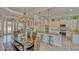 Open dining area with a view of the kitchen, bar seating, and entryway at 16307 29Th E Ct, Parrish, FL 34219