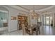 A dining room with an aged wooden table and hutch has elegant floors and unique lighting at 16307 29Th E Ct, Parrish, FL 34219