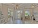 Bright foyer features wood-look floors, decorative light fixture and views to adjacent rooms at 16307 29Th E Ct, Parrish, FL 34219