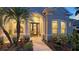 Inviting front entrance with decorative accents, lush greenery, and manicured landscaping at 16307 29Th E Ct, Parrish, FL 34219