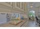 Home bar with white cabinets and granite countertop and clear view into office at 16307 29Th E Ct, Parrish, FL 34219