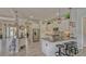 Open concept kitchen with bar seating, stainless steel appliances, and views of the office at 16307 29Th E Ct, Parrish, FL 34219
