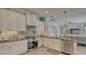 Bright kitchen with white cabinets, stainless steel appliances, and backsplash at 16307 29Th E Ct, Parrish, FL 34219