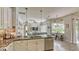 Open floor plan of kitchen features granite countertops, stainless steel appliances, and living area at 16307 29Th E Ct, Parrish, FL 34219