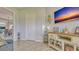 Comfortable living room with a mounted TV, wood-look flooring, and plenty of natural light at 16307 29Th E Ct, Parrish, FL 34219