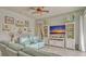 Cozy living room features neutral tones, entertainment center, and an accent ceiling fan at 16307 29Th E Ct, Parrish, FL 34219
