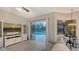 Living room featuring pool views, sliding doors, and dining area access with an ornate chandelier at 16307 29Th E Ct, Parrish, FL 34219