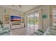 Bright living room featuring pool access, neutral colors and an entertainment center at 16307 29Th E Ct, Parrish, FL 34219