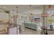 Bright open living room with comfortable seating, ceiling fan, and a view of the pool area at 16307 29Th E Ct, Parrish, FL 34219