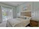 A comfortable main bedroom offers plenty of light, neutral colors, and an attached bathroom at 16307 29Th E Ct, Parrish, FL 34219