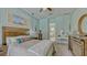 Comfortable main bedroom with attached vanity and bathroom boasts a ceiling fan and neutral walls at 16307 29Th E Ct, Parrish, FL 34219