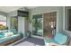 Covered patio with comfortable seating overlooks the pool area and seamlessly connects indoor and outdoor living at 16307 29Th E Ct, Parrish, FL 34219