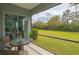 Cozy screened porch with a table and chairs and a nice view of the lawn at 16307 29Th E Ct, Parrish, FL 34219