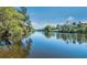 Scenic view of the tranquil river bordered by lush, green trees at 16307 29Th E Ct, Parrish, FL 34219