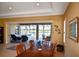 Dining room with sliders to the lanai and pool beyond at 189 Savona Way, North Venice, FL 34275