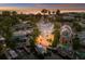 Aerial view of a waterfront home with boat dock and nearby pool at sunset at 201 N Harbor Dr, Holmes Beach, FL 34217