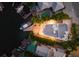 Top-down aerial view of a modern waterfront home with boat and pool at dusk at 201 N Harbor Dr, Holmes Beach, FL 34217
