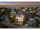 Aerial view of a modern home nestled in a waterfront community at dusk at 201 N Harbor Dr, Holmes Beach, FL 34217
