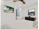 Bedroom with large TV, ceiling fan, and dresser at 201 N Harbor Dr, Holmes Beach, FL 34217