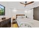 Bright bedroom with ceiling fan and wooden dresser at 201 N Harbor Dr, Holmes Beach, FL 34217
