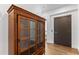 Elegant entryway with a wooden curio cabinet and modern door at 201 N Harbor Dr, Holmes Beach, FL 34217