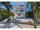 Modern two-story home with a large patio and lush landscaping at 201 N Harbor Dr, Holmes Beach, FL 34217