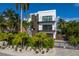 Modern two-story home with a brown garage door and a paved driveway at 201 N Harbor Dr, Holmes Beach, FL 34217