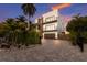 Two-story modern home with a dark brown garage door and landscaped front yard at 201 N Harbor Dr, Holmes Beach, FL 34217