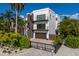 Modern two-story home with a brown garage door and a paved driveway at 201 N Harbor Dr, Holmes Beach, FL 34217