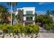 Modern two-story home with a brown garage door and a paved driveway at 201 N Harbor Dr, Holmes Beach, FL 34217