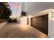 Modern home with dark brown garage and paver driveway at 201 N Harbor Dr, Holmes Beach, FL 34217