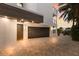 Dark brown garage door with modern entry door and paver driveway at 201 N Harbor Dr, Holmes Beach, FL 34217