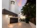 Modern garage with dark brown door and paver driveway at 201 N Harbor Dr, Holmes Beach, FL 34217