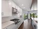 Modern kitchen with stainless steel appliances and white cabinets at 201 N Harbor Dr, Holmes Beach, FL 34217