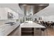 Modern kitchen with island, stainless steel appliances, and white cabinetry at 201 N Harbor Dr, Holmes Beach, FL 34217