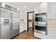 Modern kitchen with stainless steel appliances and white cabinets at 201 N Harbor Dr, Holmes Beach, FL 34217