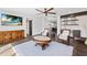 Open living area with wet bar, leather furniture, and hardwood floors at 201 N Harbor Dr, Holmes Beach, FL 34217