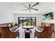 Spacious living room with large windows, leather furniture, and hardwood floors at 201 N Harbor Dr, Holmes Beach, FL 34217