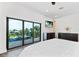 Main bedroom with sliding glass doors and water views at 201 N Harbor Dr, Holmes Beach, FL 34217