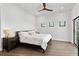 Main bedroom with a king-size bed, two nightstands and ceiling fan at 201 N Harbor Dr, Holmes Beach, FL 34217