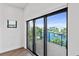 Main bedroom with sliding glass doors leading to a balcony at 201 N Harbor Dr, Holmes Beach, FL 34217