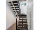 Contemporary floating staircase with dark wood steps and metal railing at 201 N Harbor Dr, Holmes Beach, FL 34217