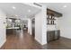 Modern wet bar with dark wood cabinets, floating shelves, and a farmhouse sink at 201 N Harbor Dr, Holmes Beach, FL 34217